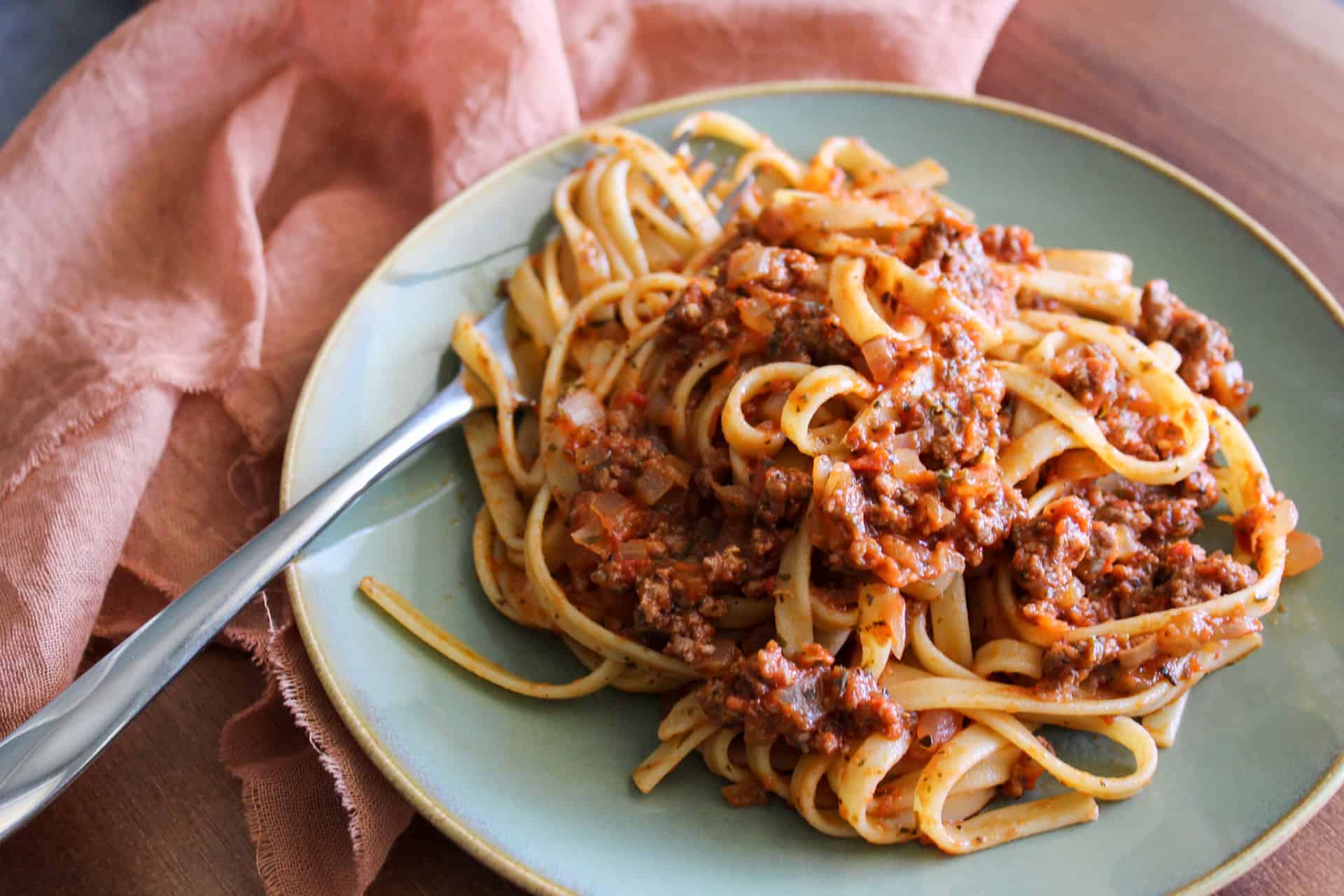 A plate of fettuccine with a hearty Italian meat sauce