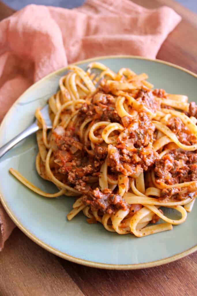 A plate of Italian fettuccine with meat sauce