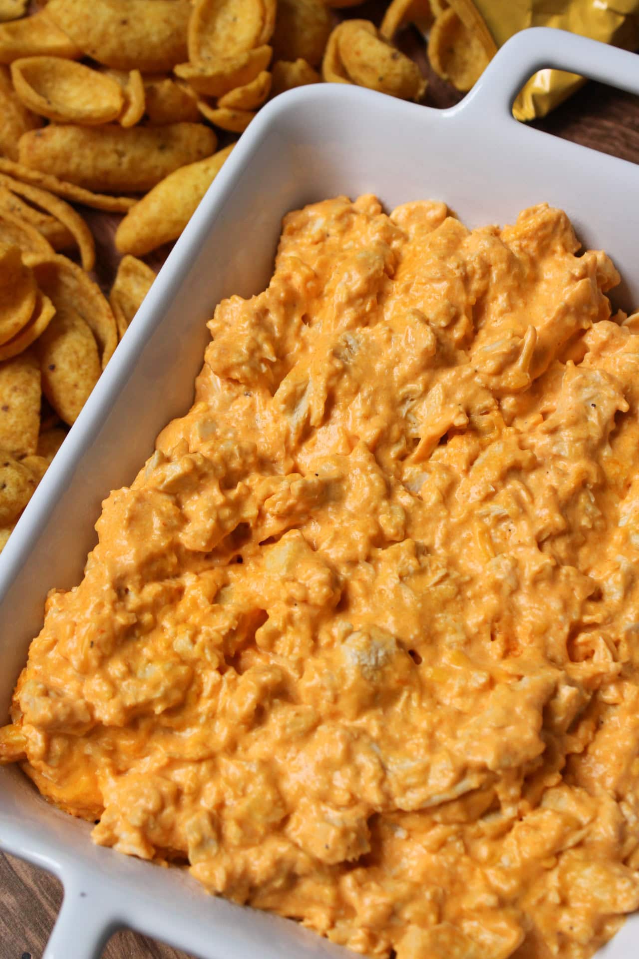 Creamy buffalo chicken dip in a white serving dish.