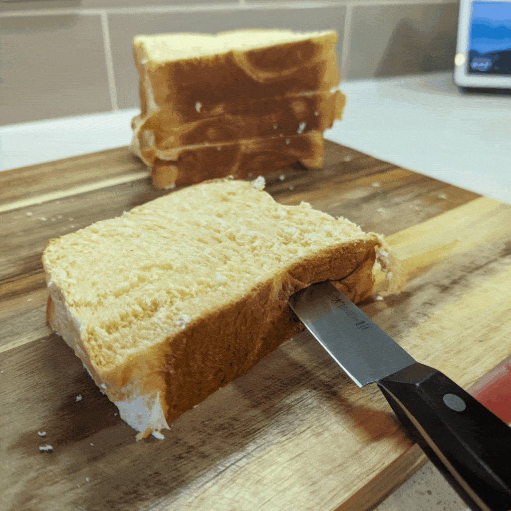 A GIF showing how to slice a pocket in the brioche to stuff it with Nutella