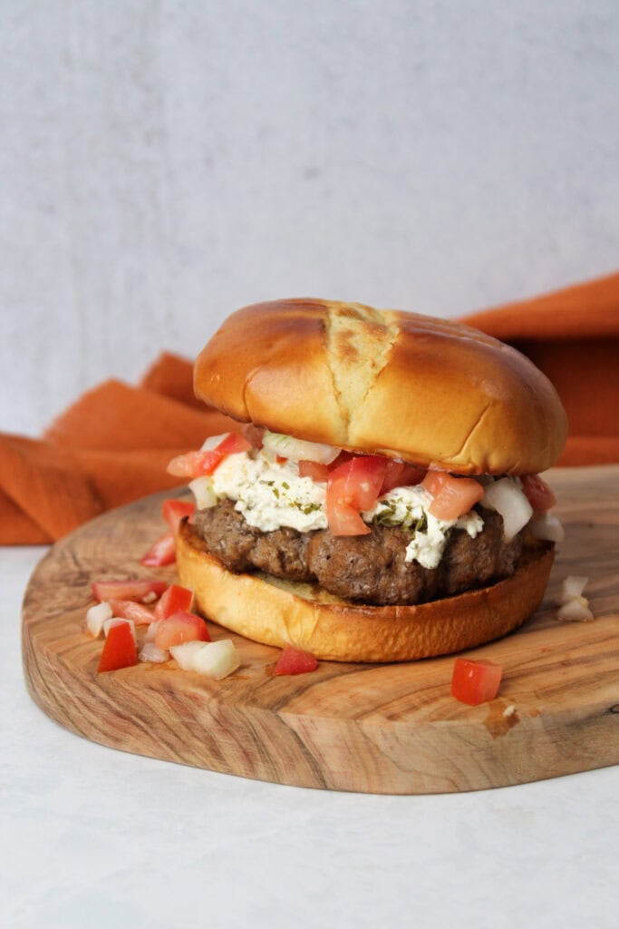 A burger with bruschetta.