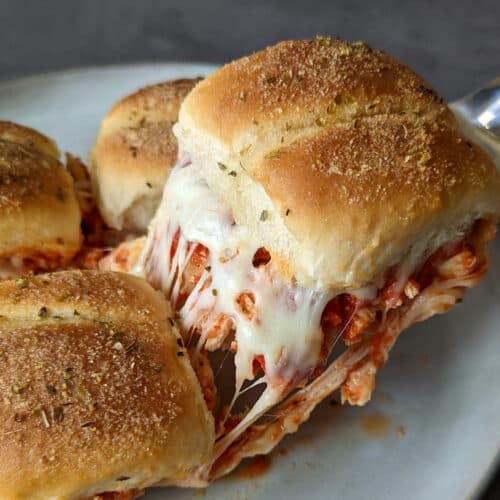Cheesy chicken parm sliders being served from a plate