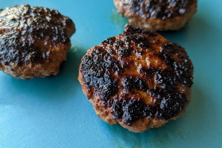 Grilled burger patties on a plate