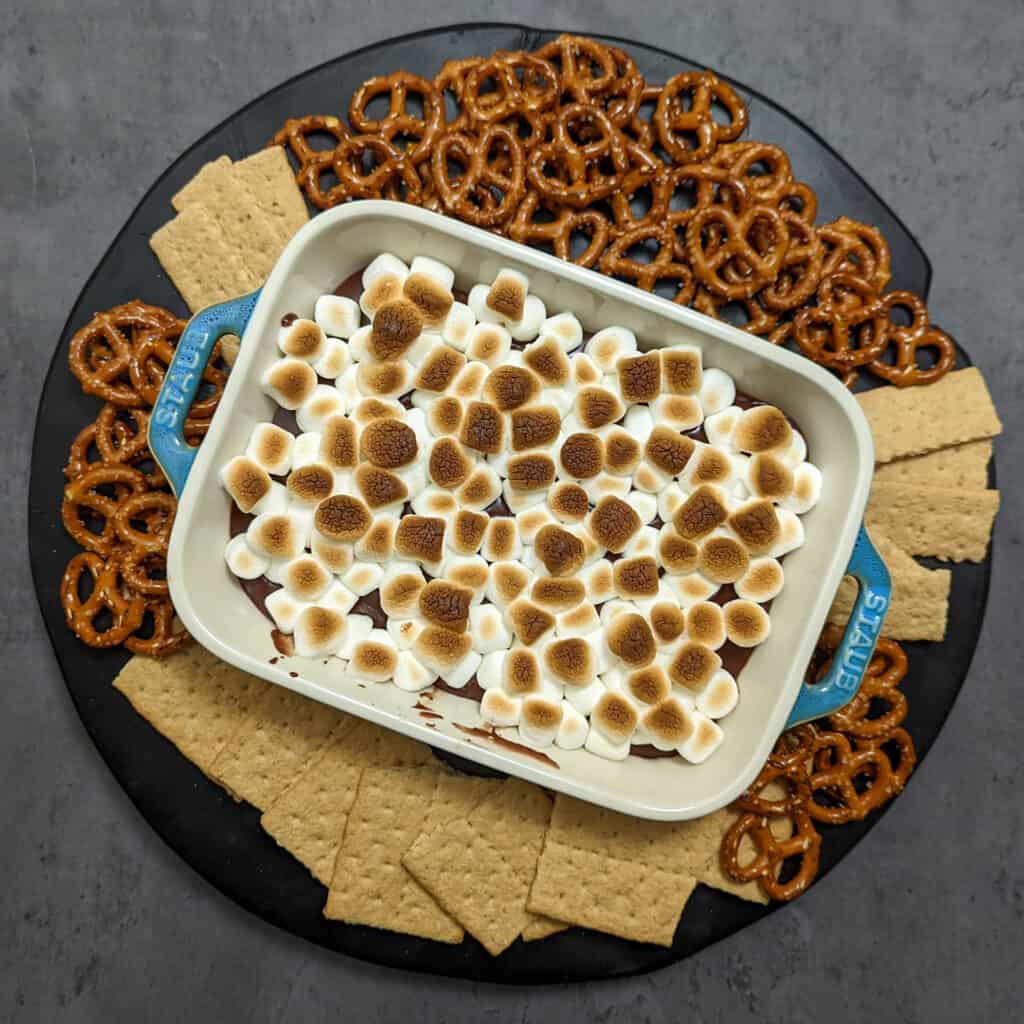 S'mores dip with mini marshmallows, served with pretzels and graham crackers