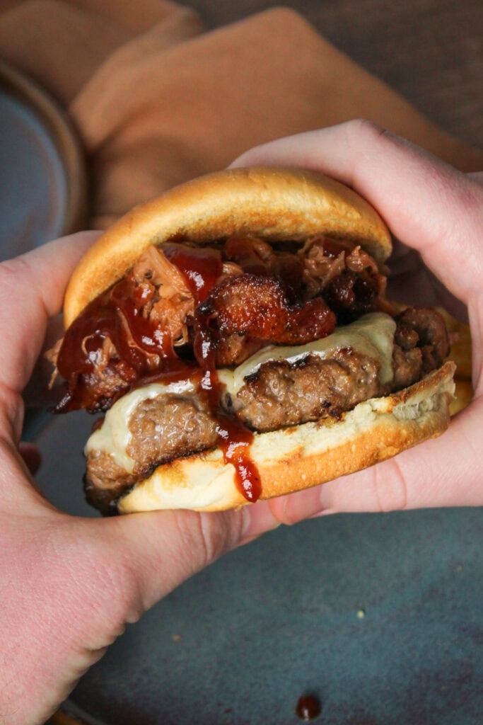 A barbecue pulled pork burger with bacon and cheese.