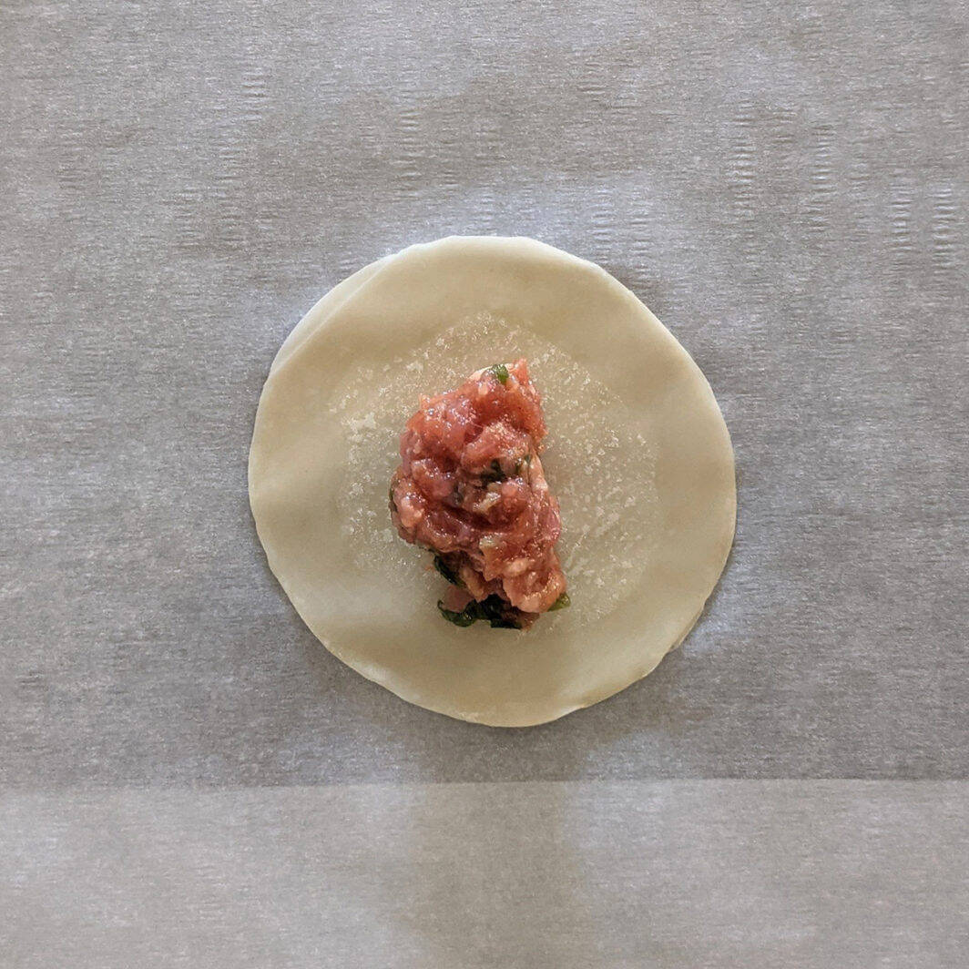 A pork meatball on a dumpling wrapper