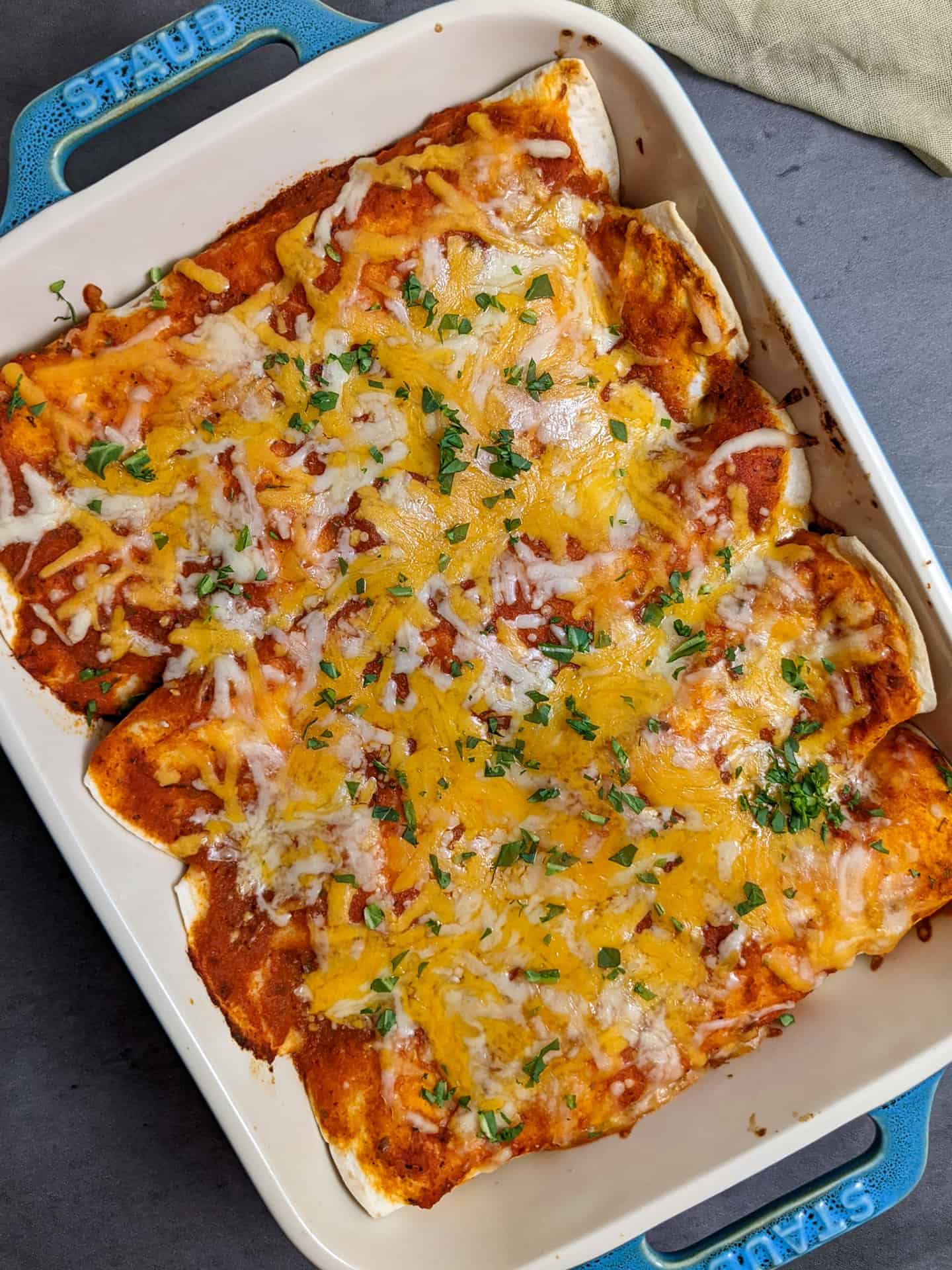 Sweet potato black bean enchiladas in a casserole dish