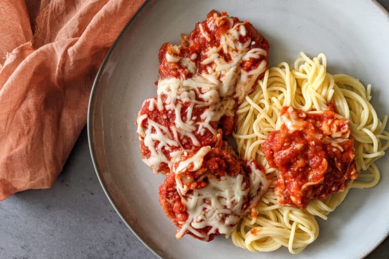 A plate of spaghetti and eggplant parm