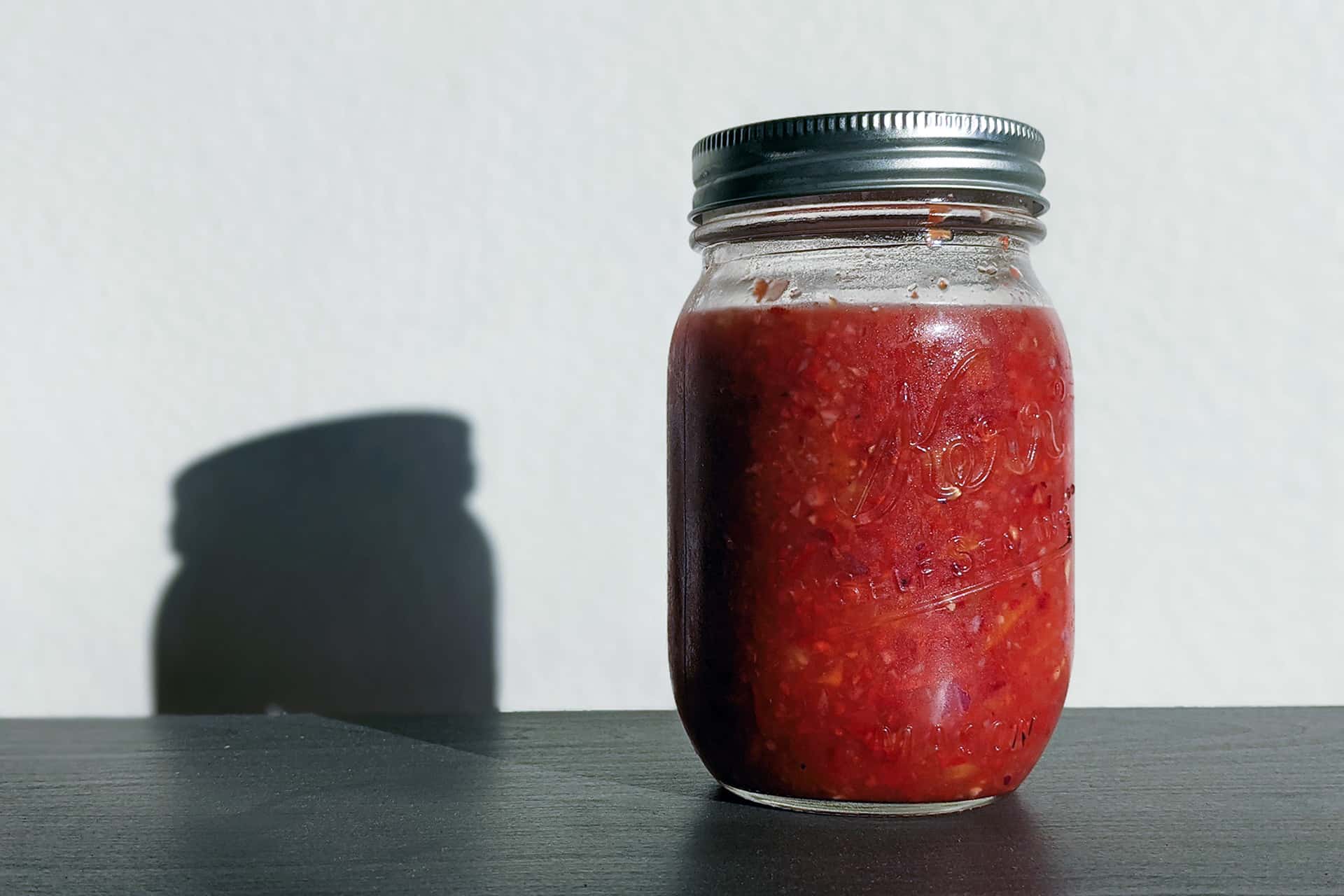 A mason jar of fresh homemade salsa