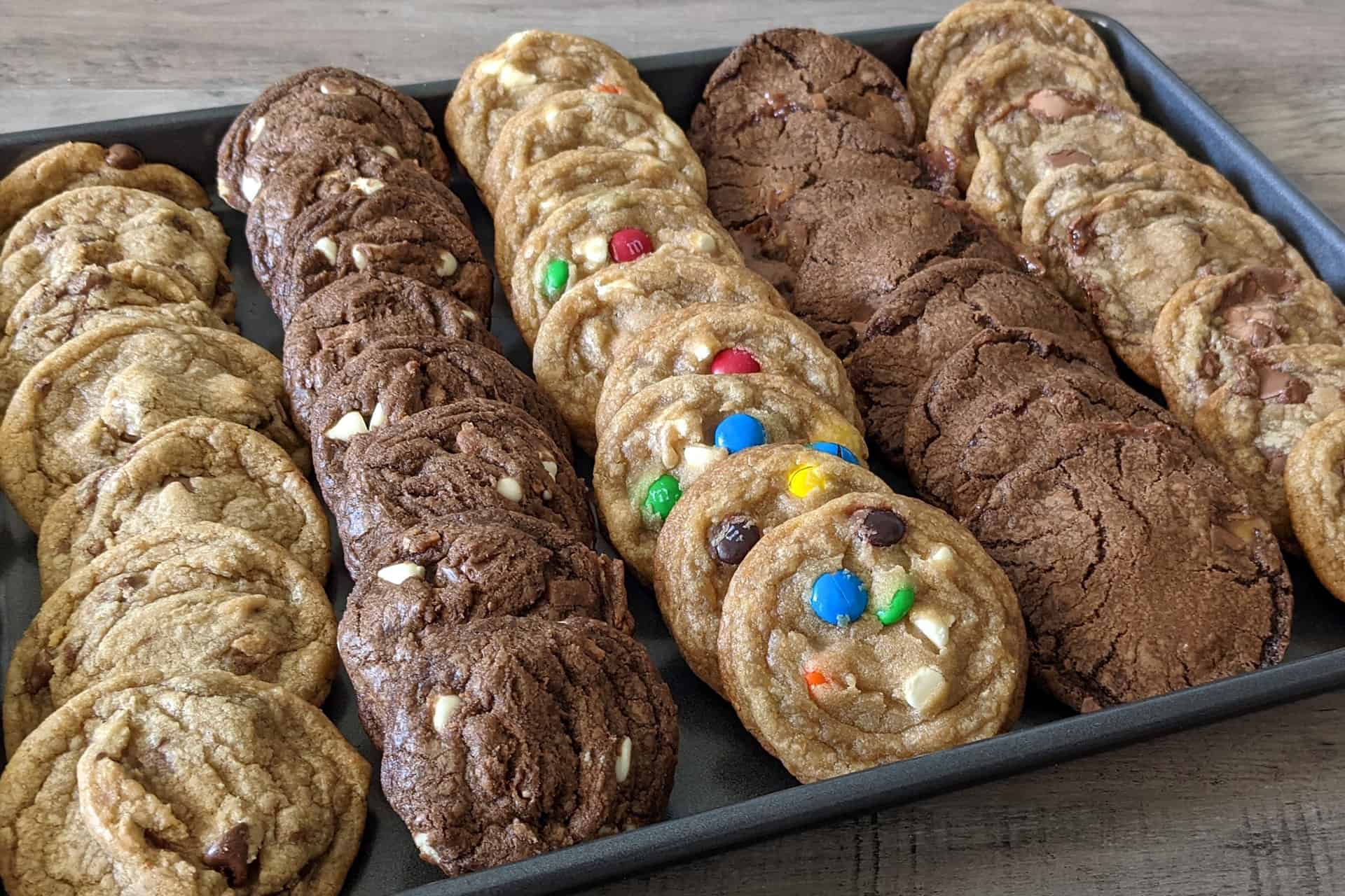 Different types of cookies made with leftover Halloween candy displayed on a sheet pan