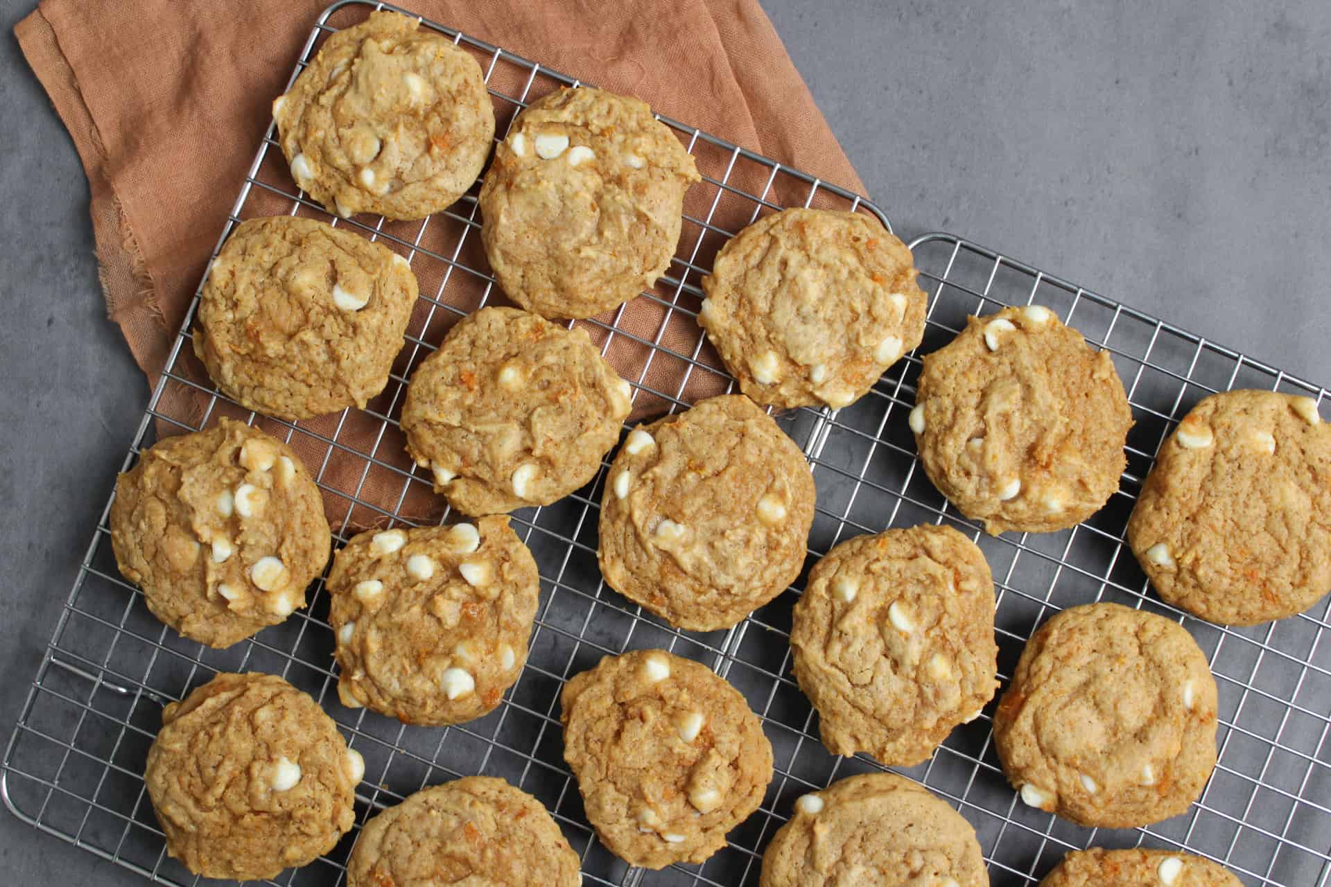 Sweet potato white chocolate chip cookies on a cooling rack.