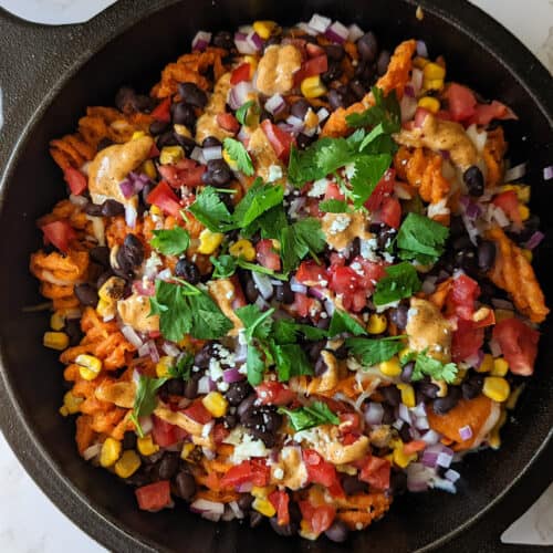 Sweet potato waffle fries loaded with cheese, beans, tomato, and onion