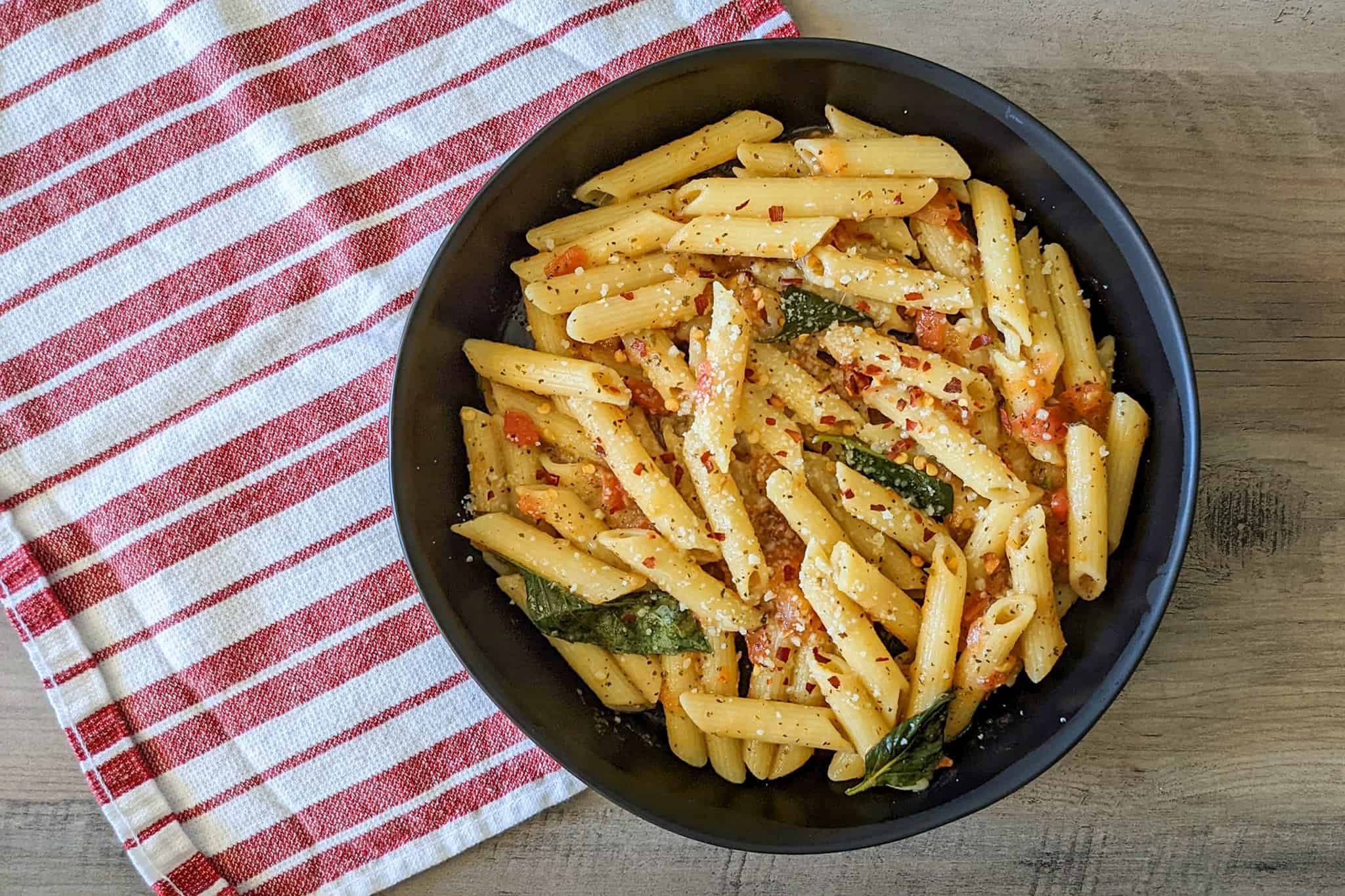 A bowl of Tuscan penne pasta made with fresh tomatoes and basil