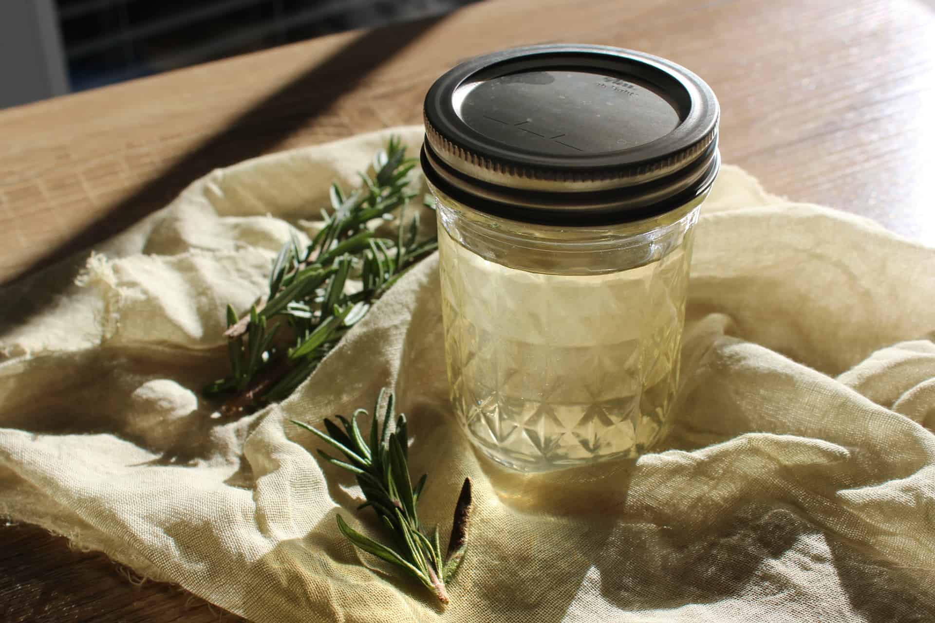 A mason jar full of homemade rosemary simple syrup
