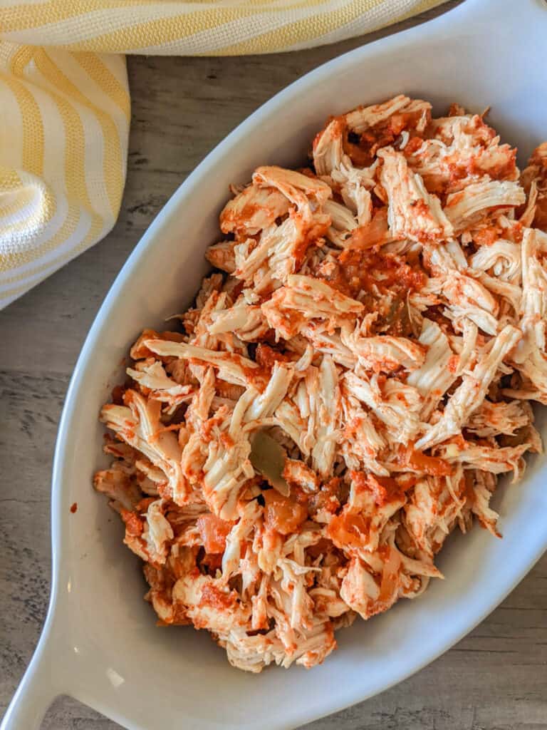 Salsa-marinated shredded chicken in a serving dish