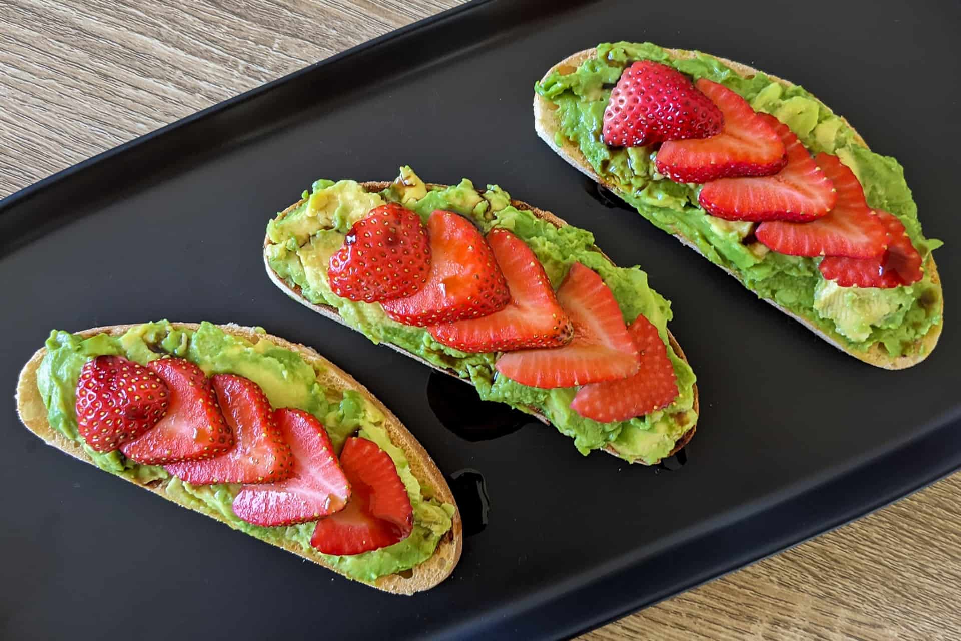 A plate of strawberry balsamic avocado toast