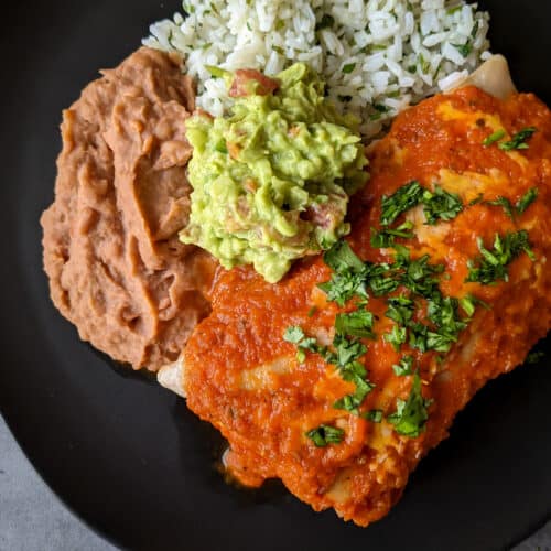 A homemade chicken burrito ranchero plated for dinner