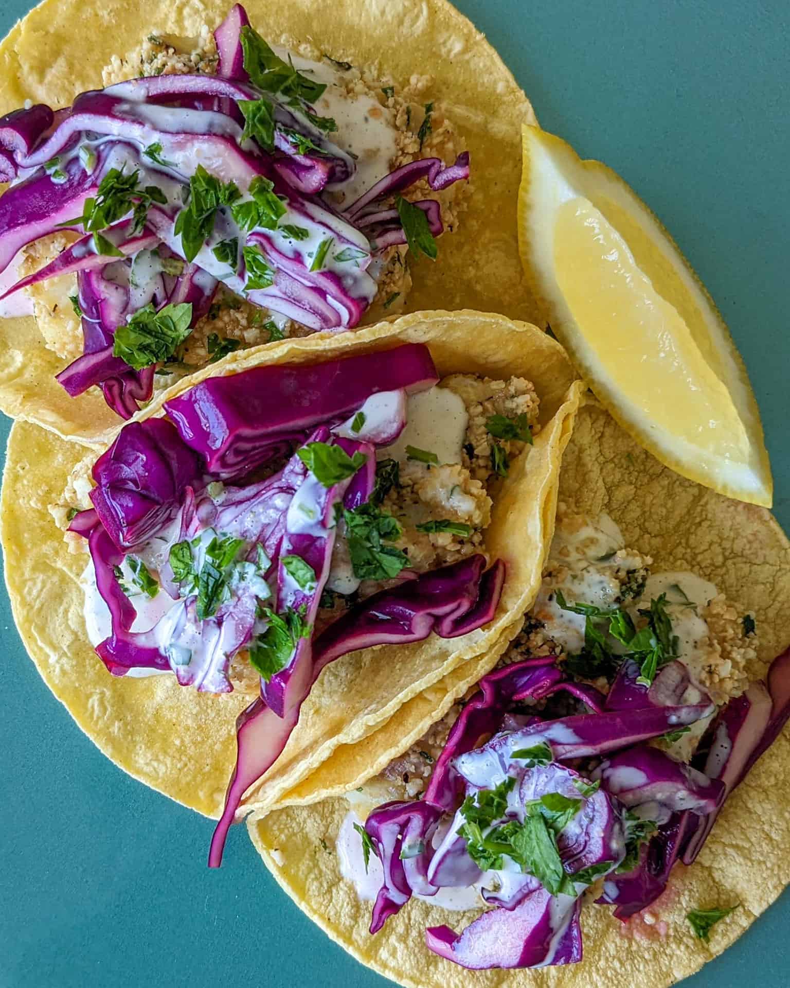 Cashew crusted fried fish tacos with pickled cabbage and lemon aioli