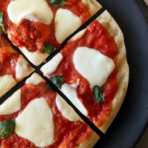 A grilled margherita pizza with fresh mozzarella and basil