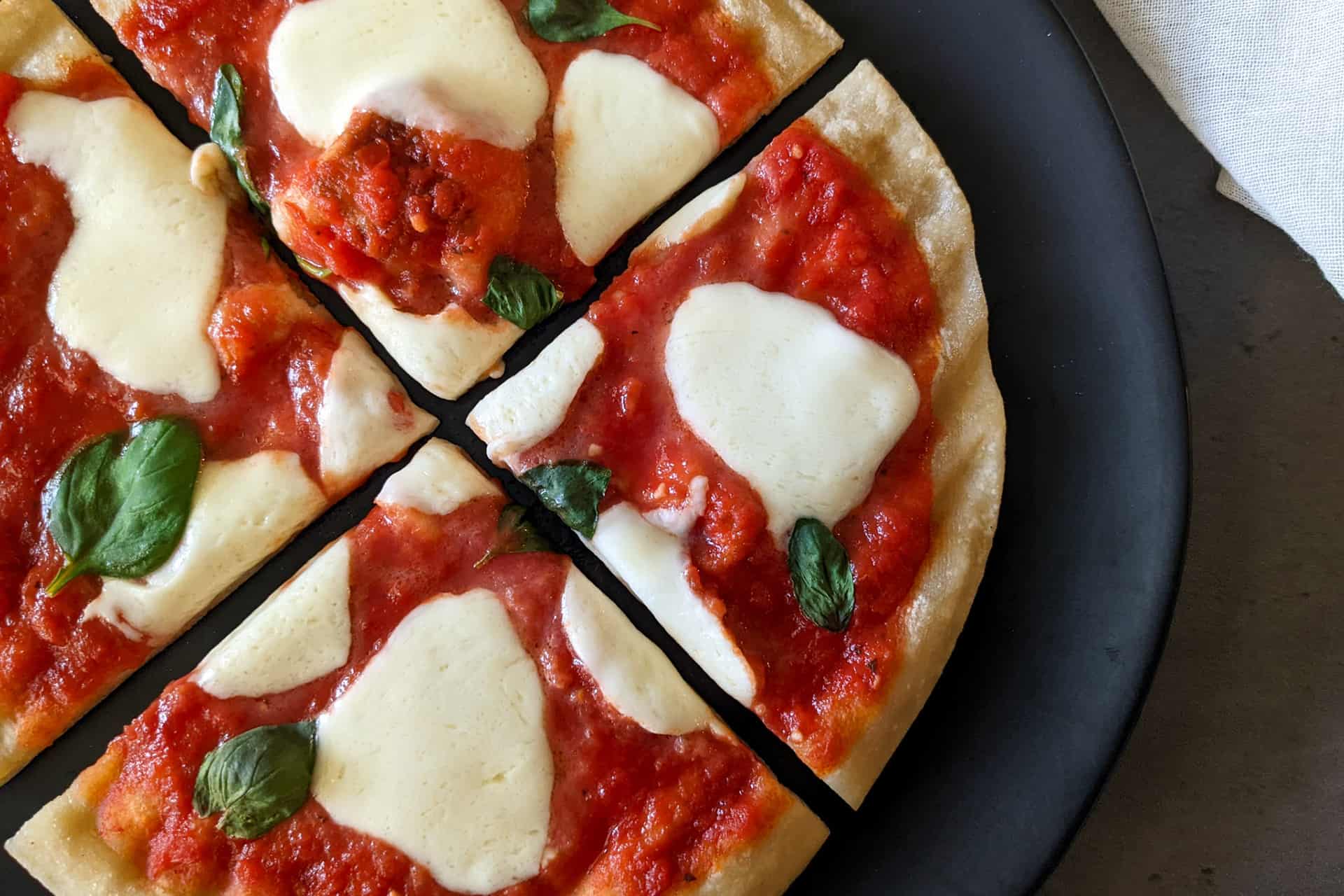 A grilled margherita pizza with fresh mozzarella and basil