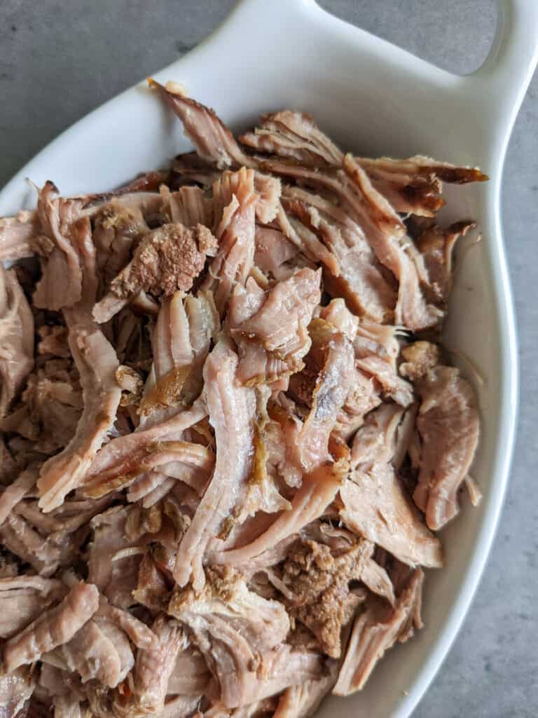 Slow cooker pulled pork in a serving dish.