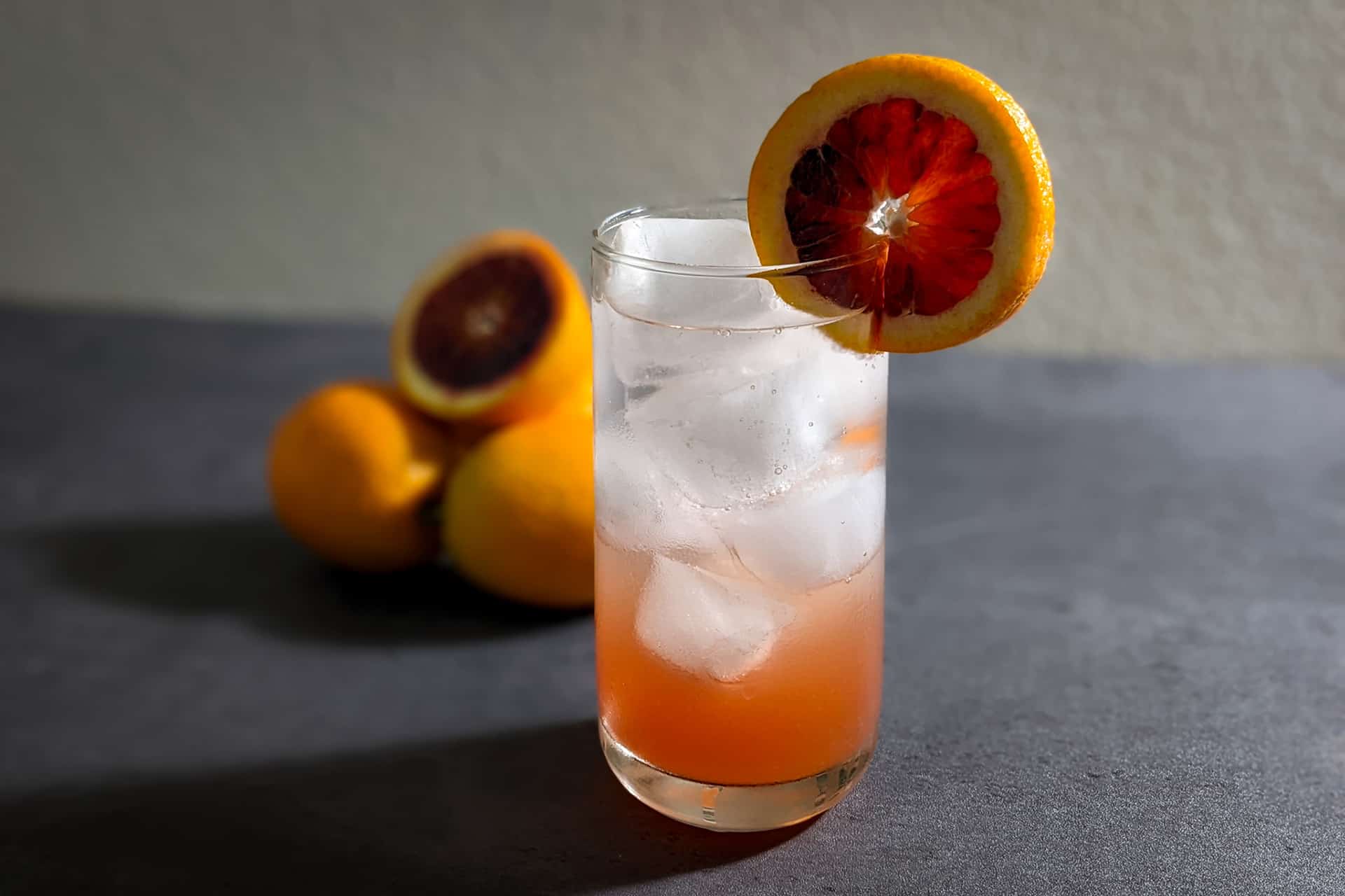 A vodka soda made with blood orange juice
