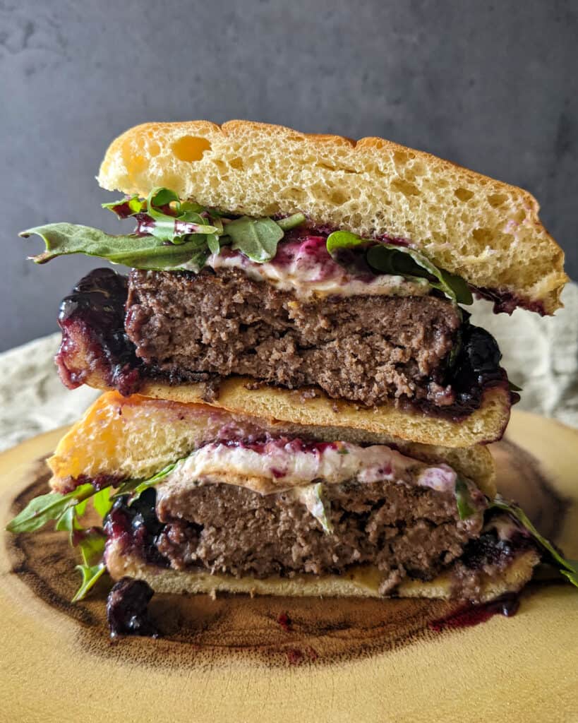Two halves of a blueberry lemon goat cheese burger stacked on top of each other