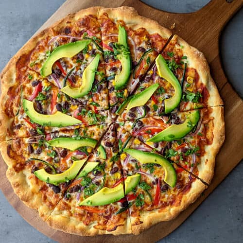 A California style veggie pizza topped with avocado slices