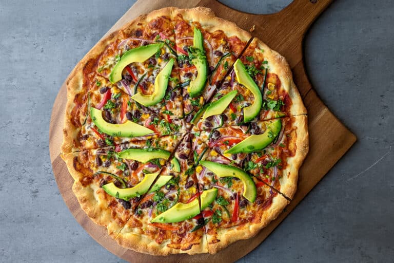 A California style veggie pizza topped with avocado slices