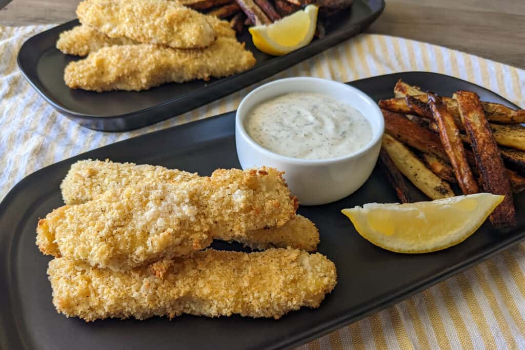 A plate of parmesan panko crusted fish and chips with homemade lemon aioli