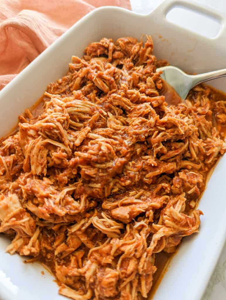 A big serving dish of chicken tinga made in a slow cooker