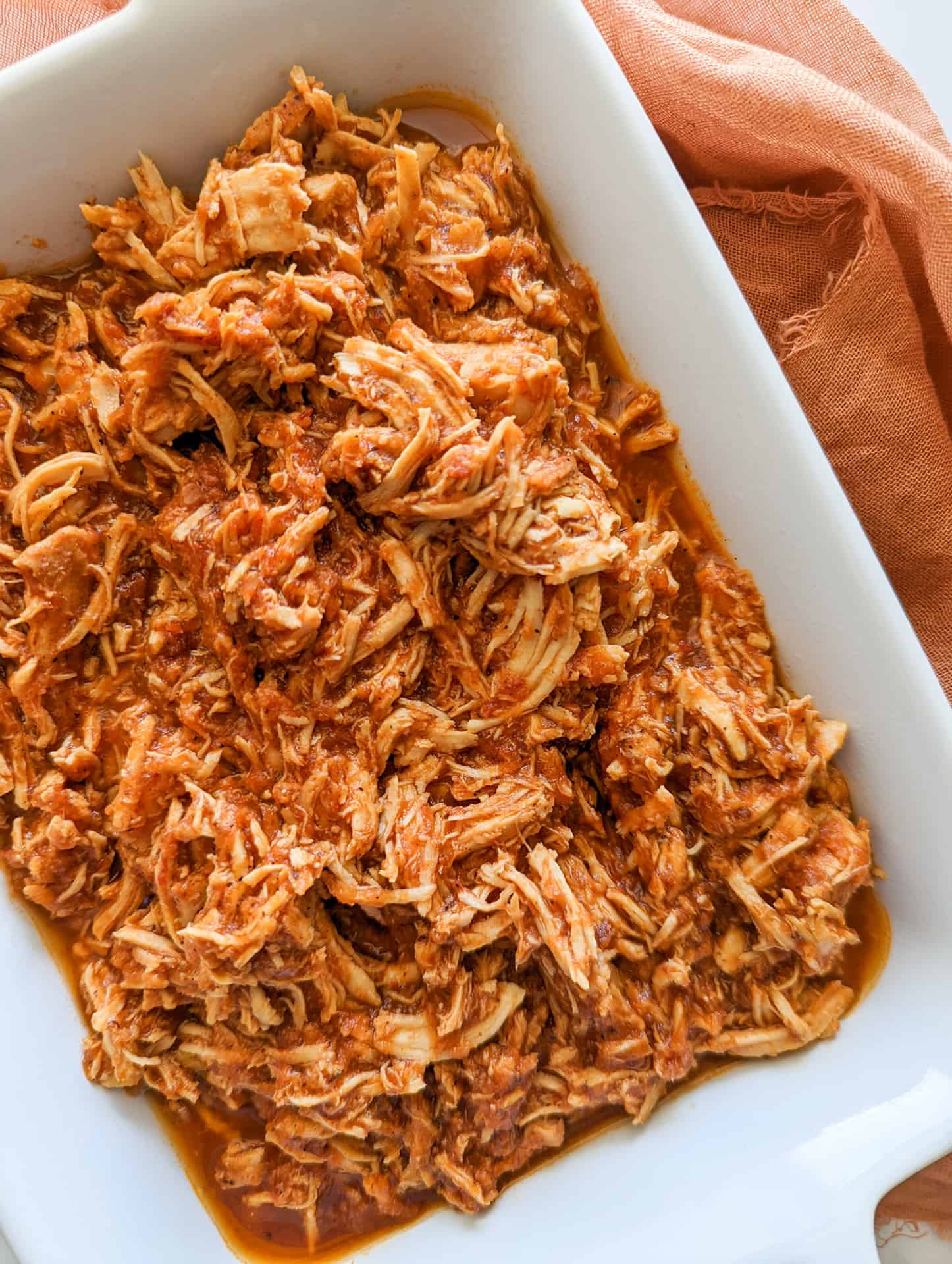 Shredded slow cooker chicken tinga in a serving dish