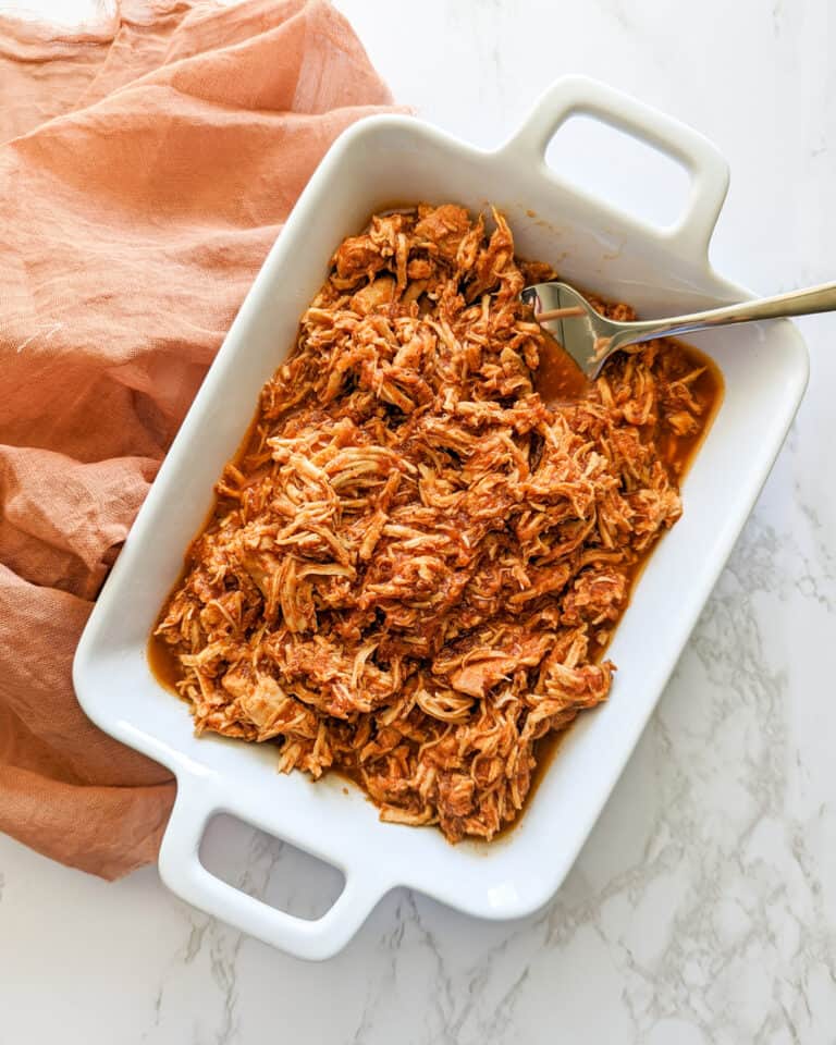 A dish of slow cooker chicken tinga served with a fork