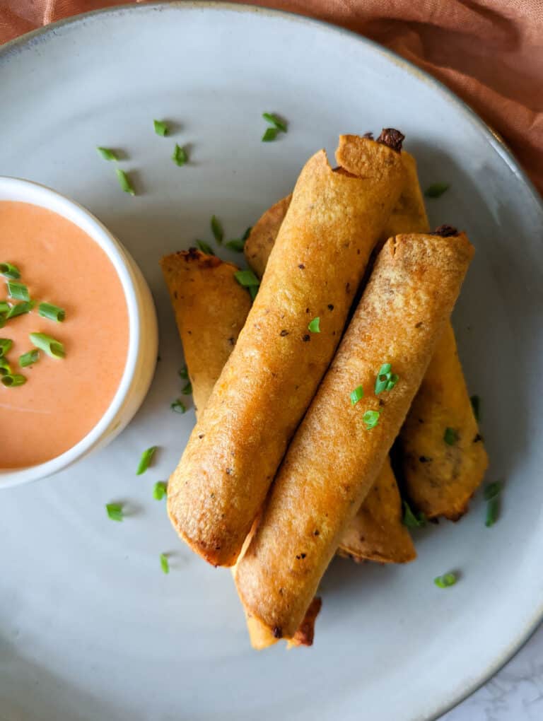 Air fryer buffalo chicken taquitos served with buffalo ranch dipping sauce
