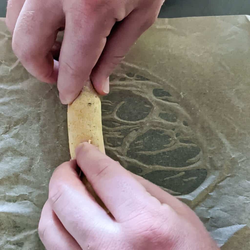 Rolling a corn tortilla into a taquito