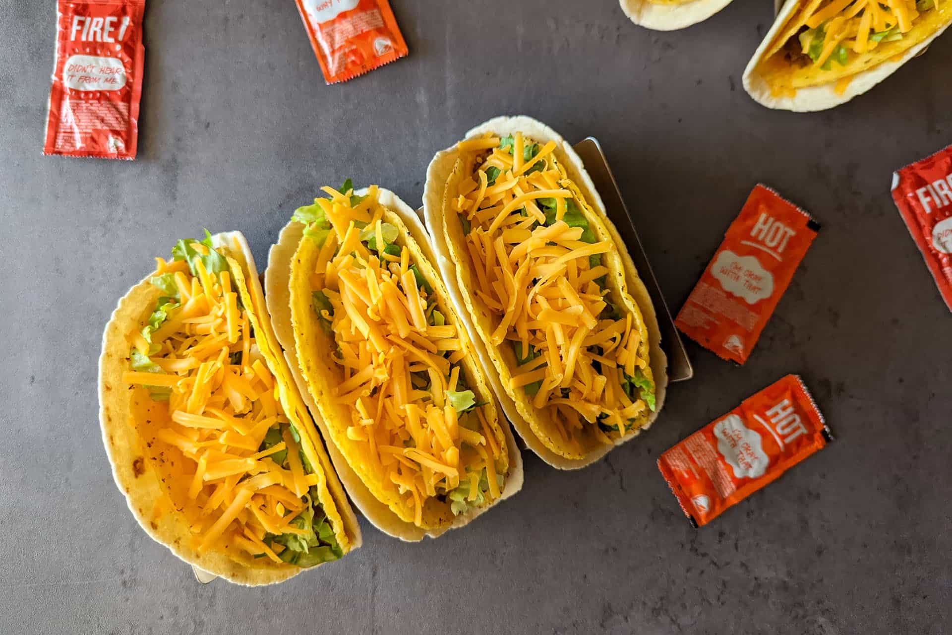 Taco bell copycat cheesy gordita crunch tacos with taco bell hot sauce
