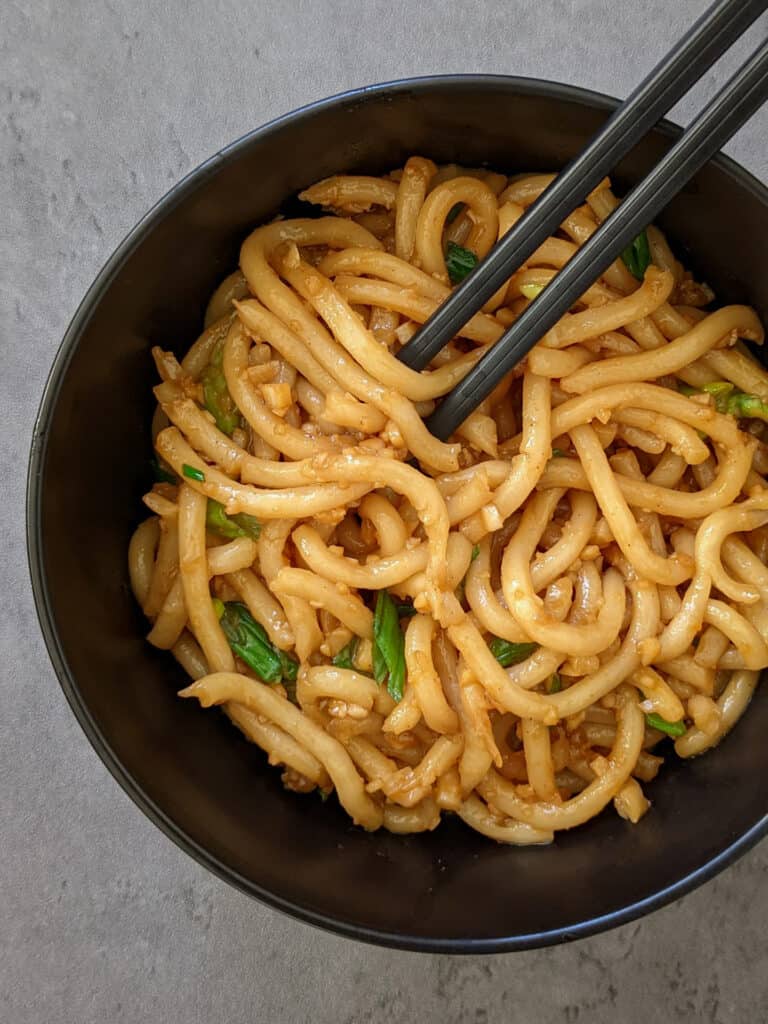 A bowl of savory garlic noodles made with Japanese udon