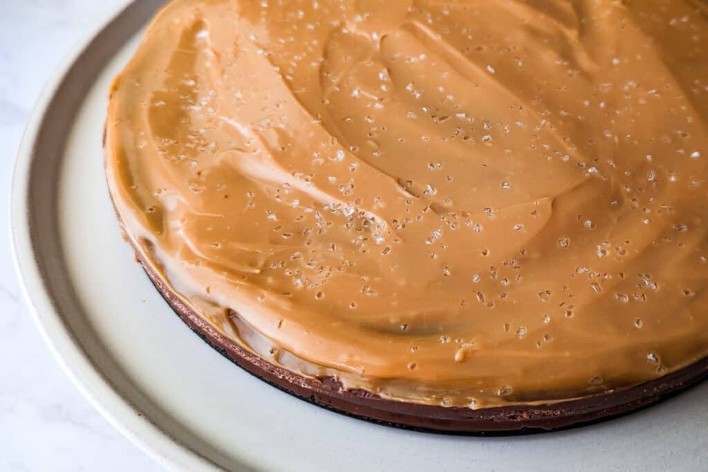 Chocolate fudge topped with sea salt caramel served on a cake stand