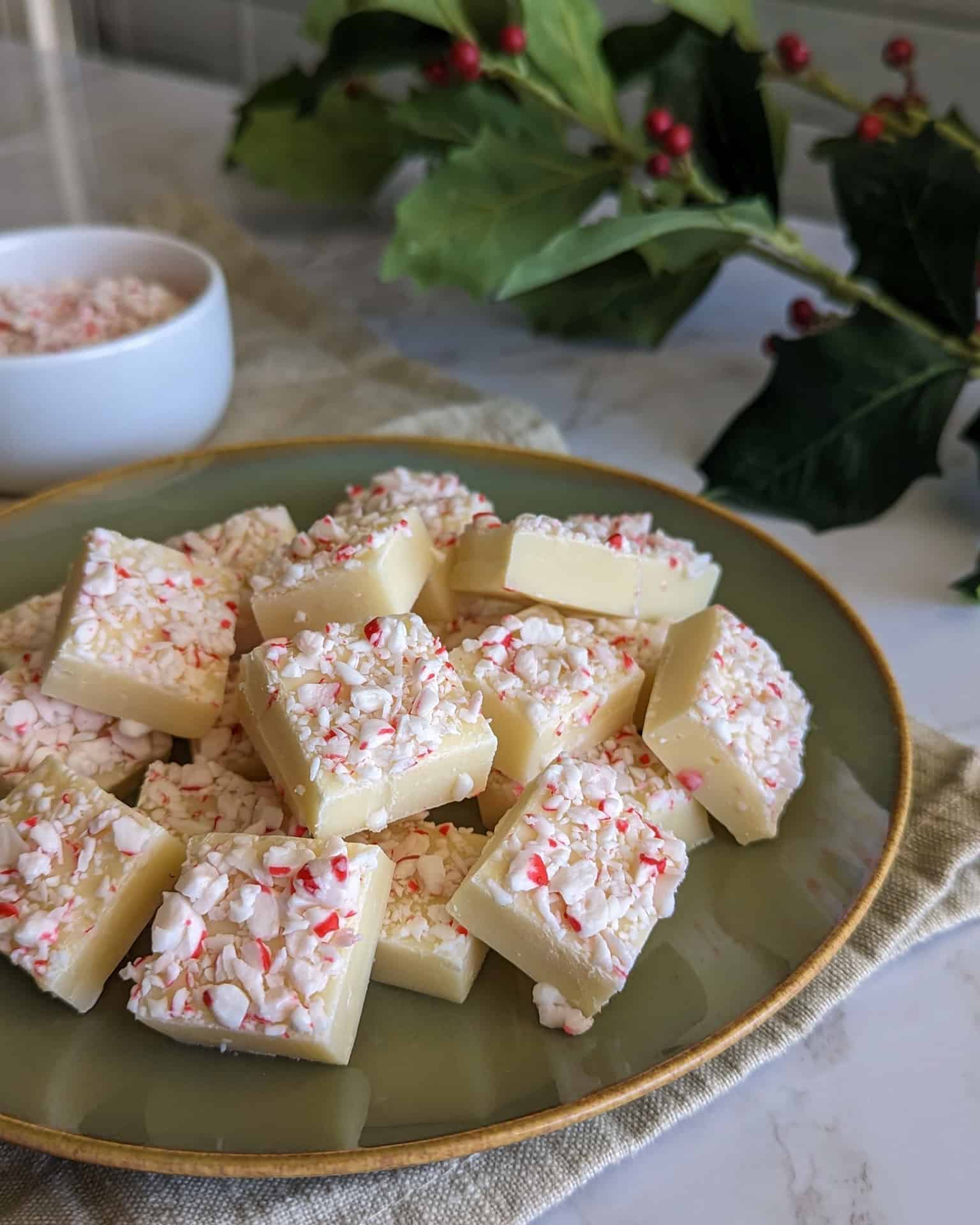 A plate of white chocolate peppermint fudge topped with crushed candy canes.