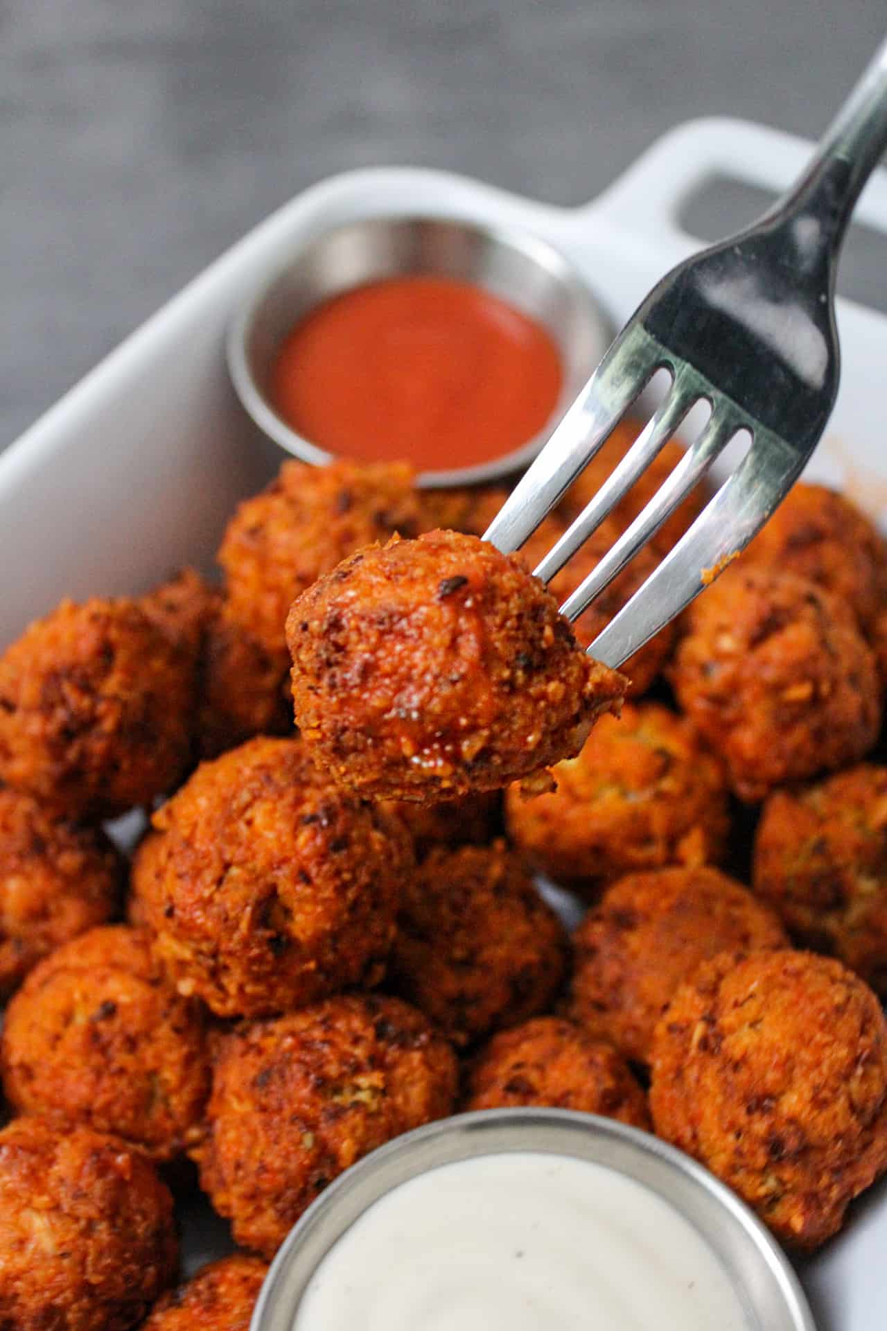 A fork picking up an air fryer buffalo cauliflower bite