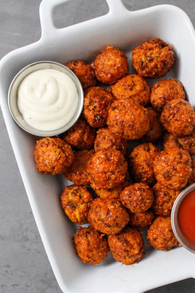 Air fryer buffalo cauliflower bites served with ranch and extra hot sauce