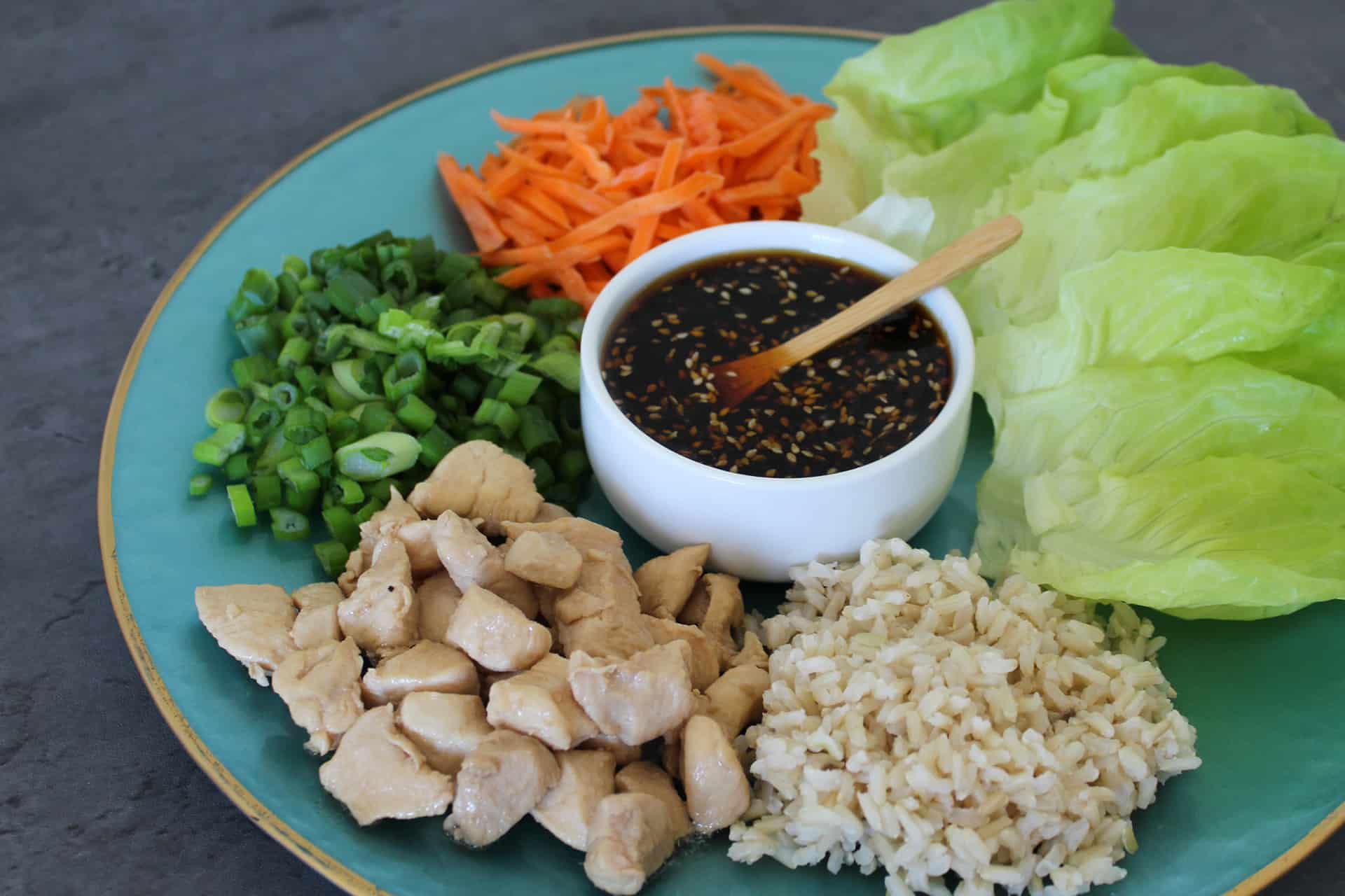A platter of deconstructed Asian chicken lettuce wraps for serving at the table