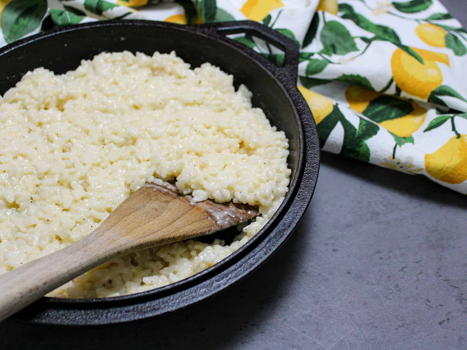 A cast iron pan filled with creamy risotto made from scratch