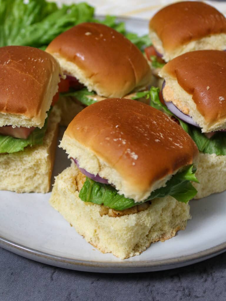 Healthy grilled chicken sliders with lettuce, tomato, onion, and chipotle mayo