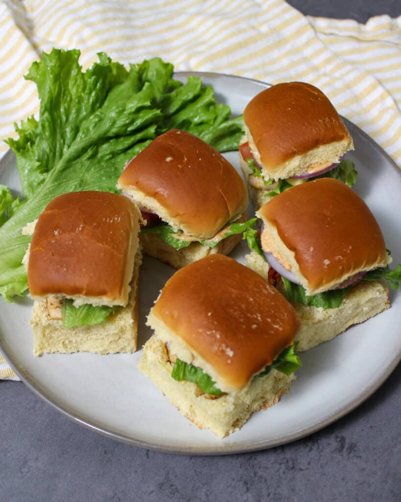 A plate with 5 healthy grilled chicken sliders on it