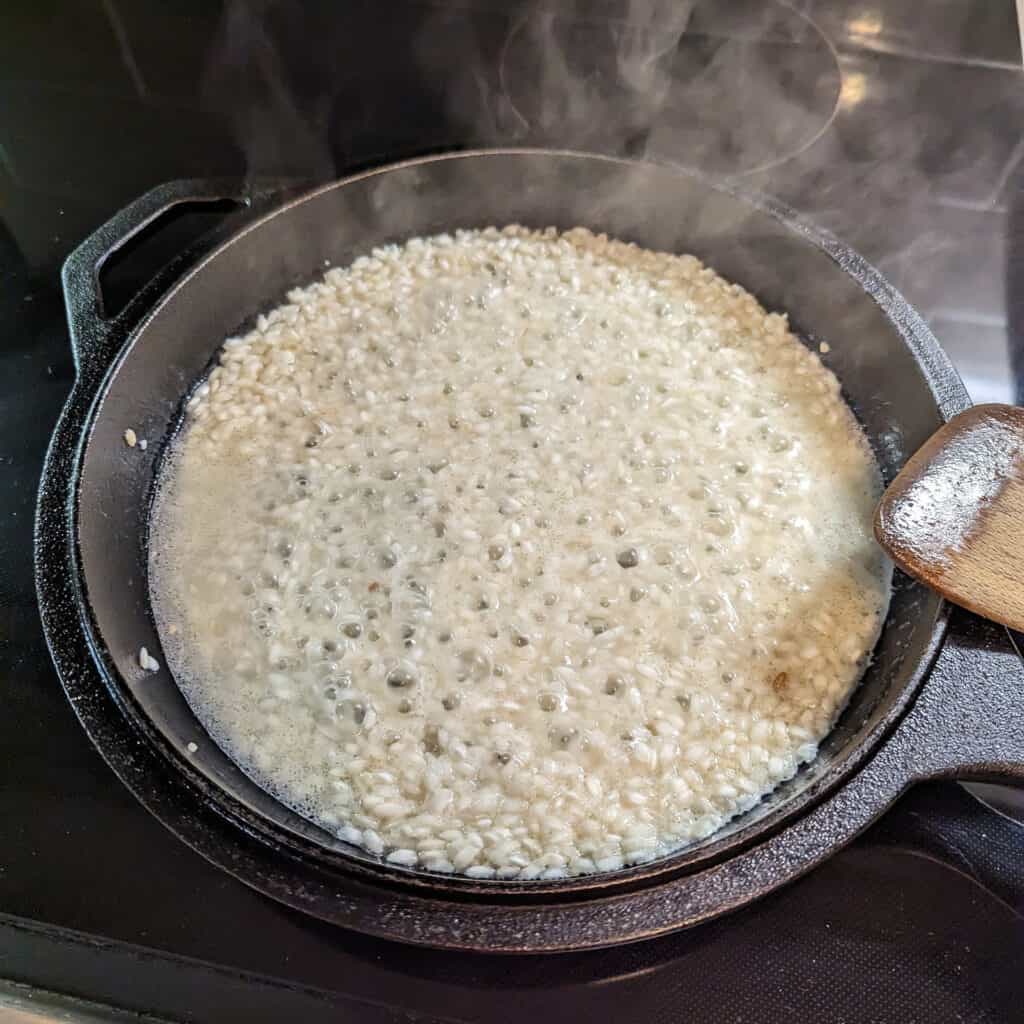 Risotto cooking on the stove in chicken broth
