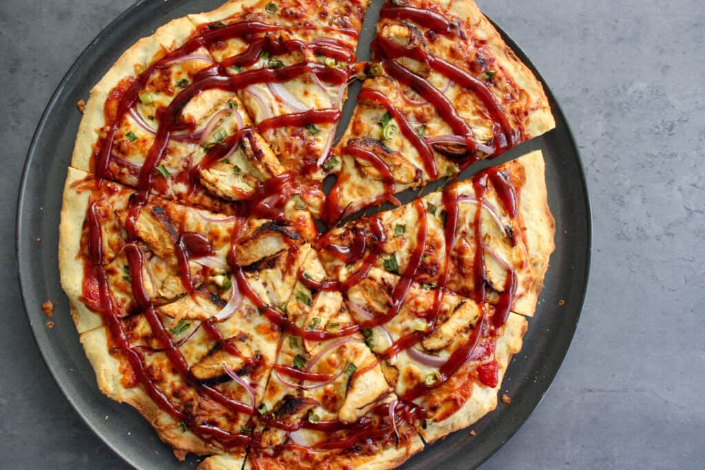 A homemade barbecue chicken pizza on thin crust