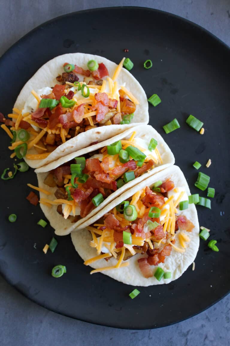 3 loaded baked potato tacos on a plate