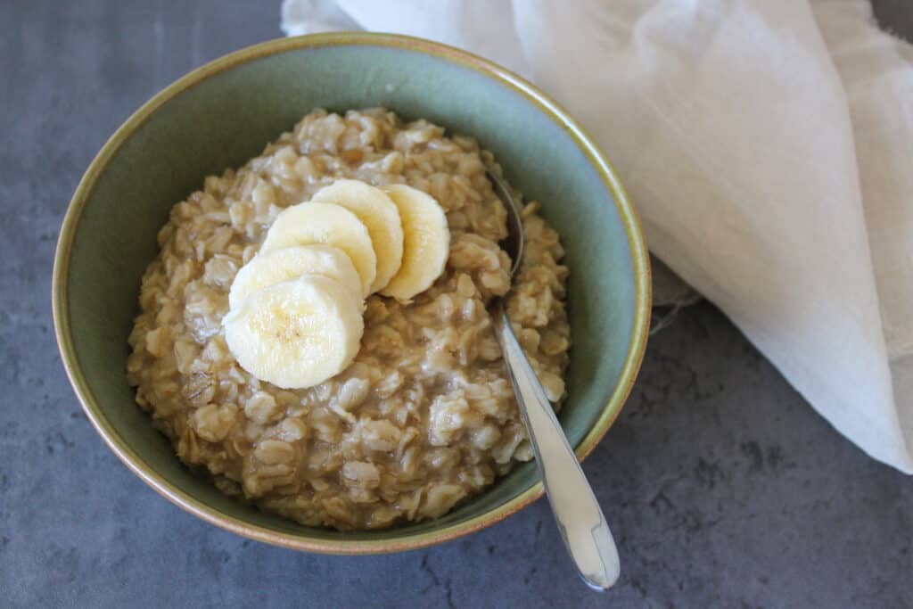 Maple brown sugar oatmeal in a bowl topped with bananas