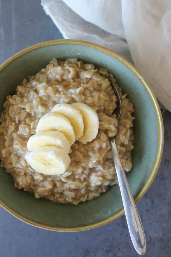 A bowl of maple brown sugar oatmeal topped with fresh banana slices